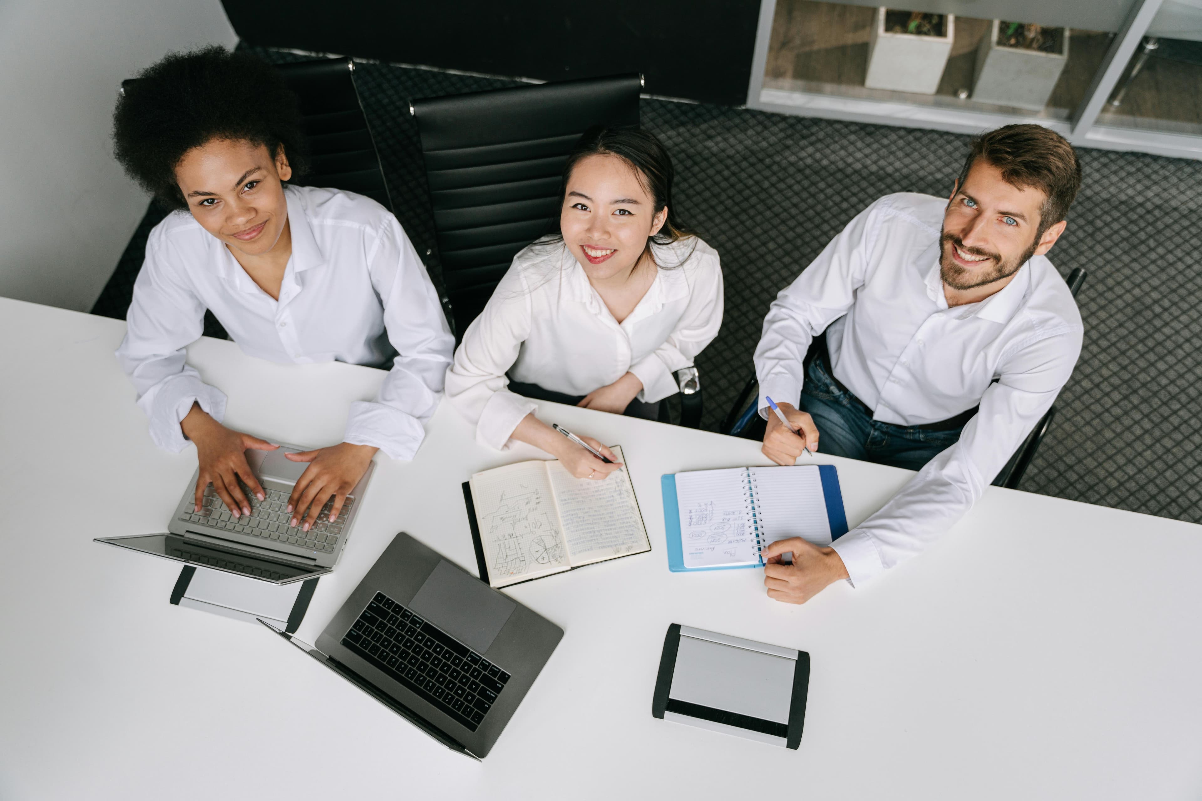 Overhead view of a team collaborating around business materials