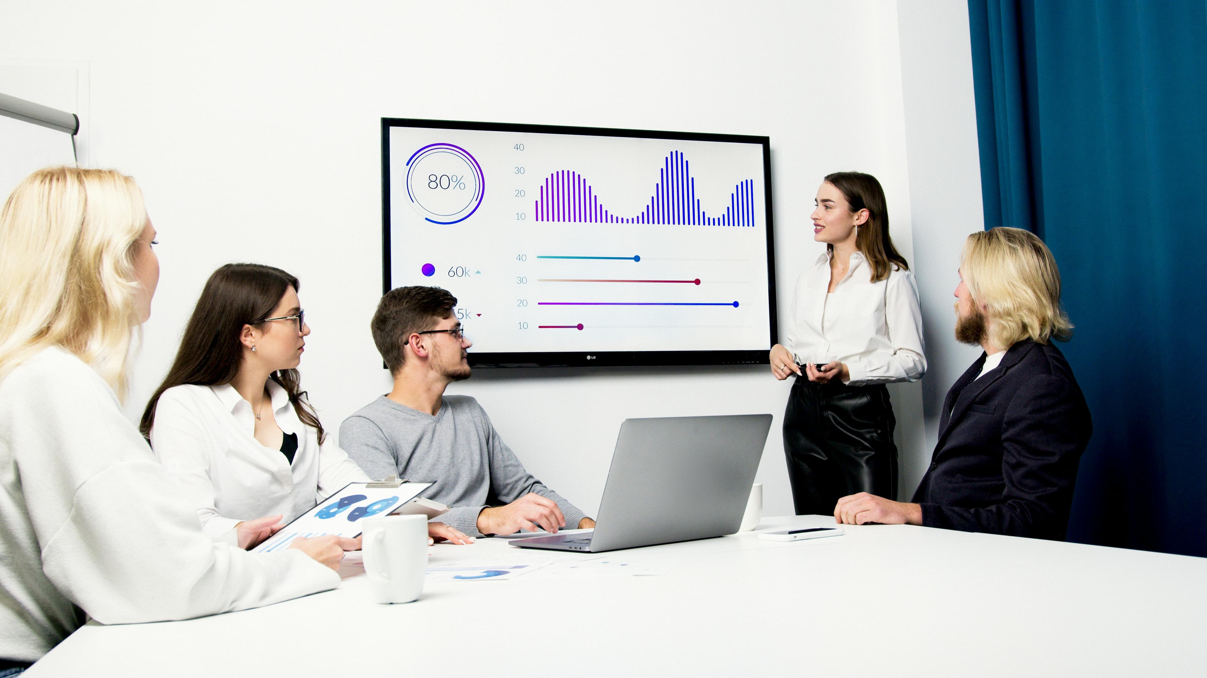 Business team reviewing data and strategy presentation materials