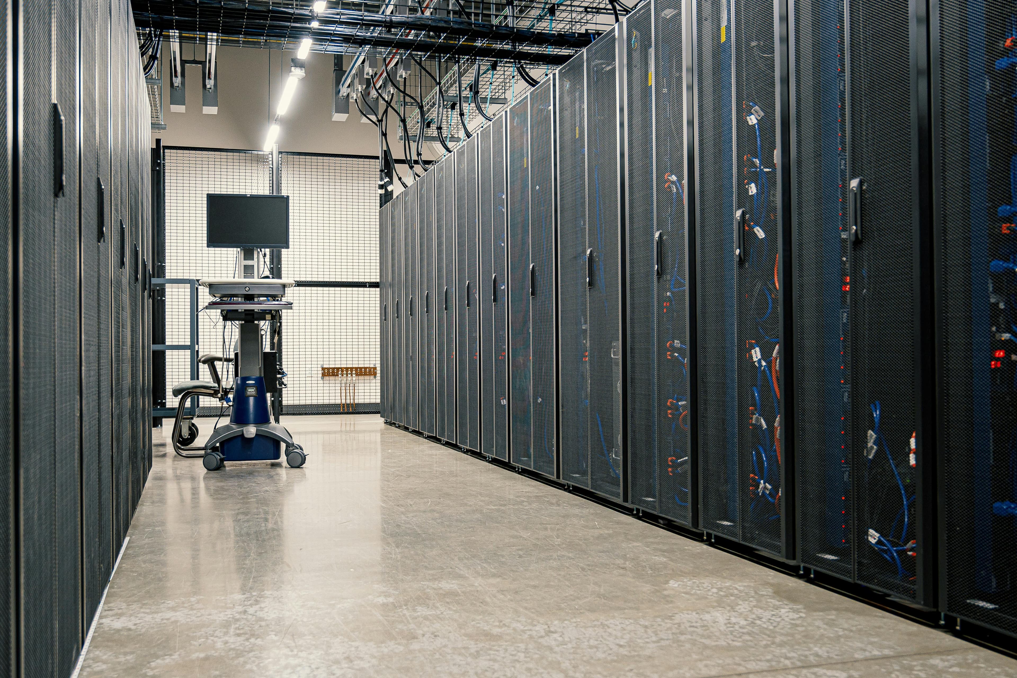 Data center aisle with server racks and infrastructure equipment