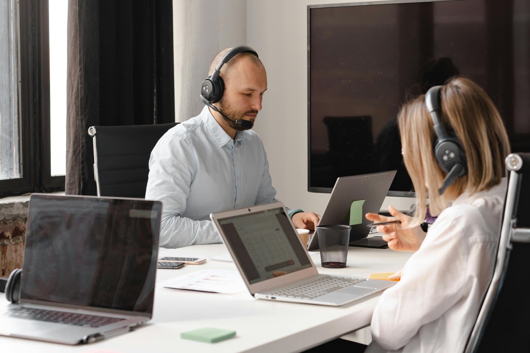 Help desk support team using headsets to assist users